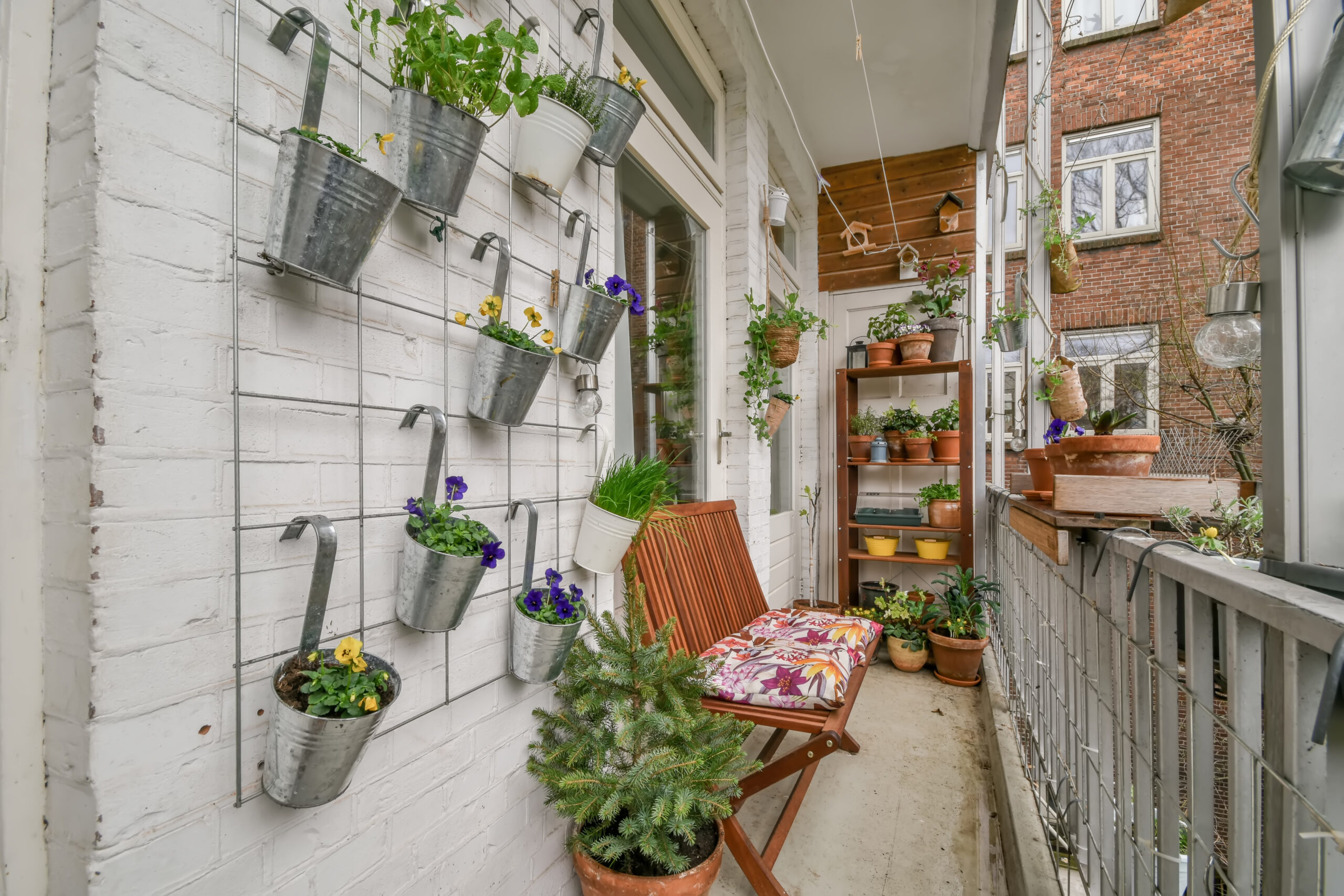 The balcony is fully furnished with home flowers